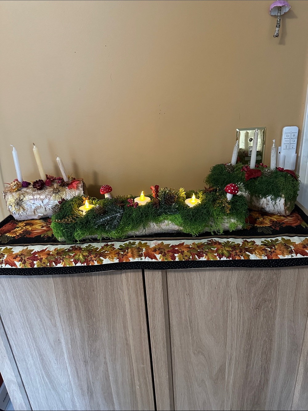 Moss-Covered Holiday Centerpiece with Red Mushroom Accents